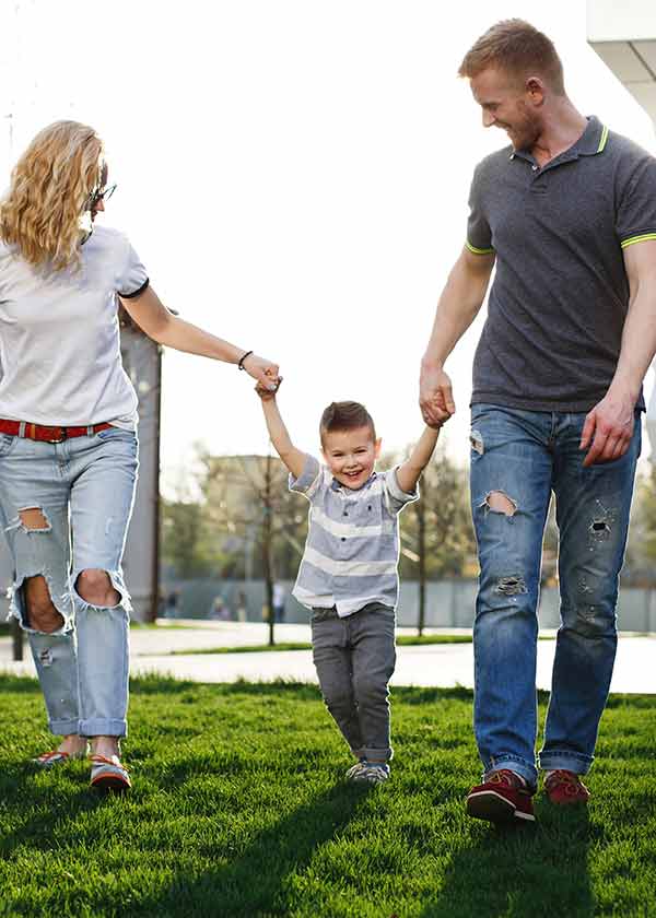 mom-dad-whirl-their-son-have-fun-walking-outside
